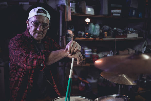 istock An older man practices playing drums in his garage 1340971993