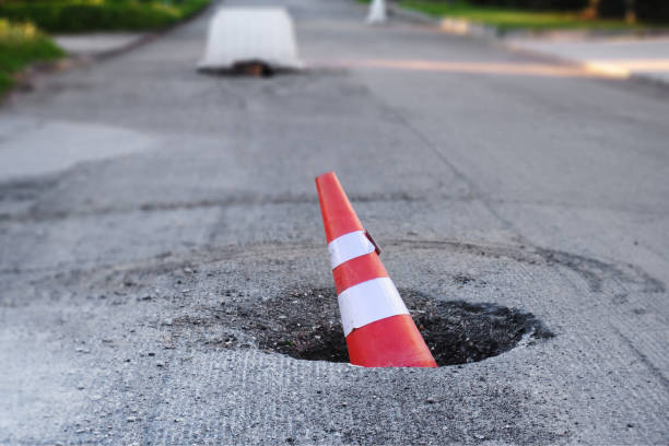 istock The traffic cone lies in the road pit 1340973890