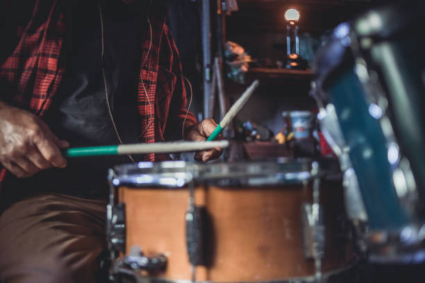 istock An older man practices playing drums in his garage 1340974093