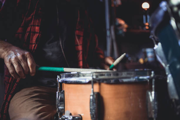 The older man, the older man who practices playing drums in his garage, reminds him of the days when he ruled the stage at concerts.