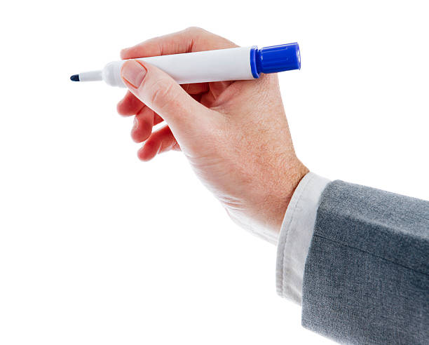istock Businessman's hand holds uncapped blue highlighter against white background. 134097446