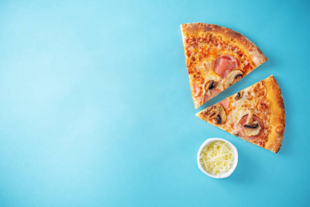 istock Fresh baked pizza with ham and mushrooms on a background 1340975028