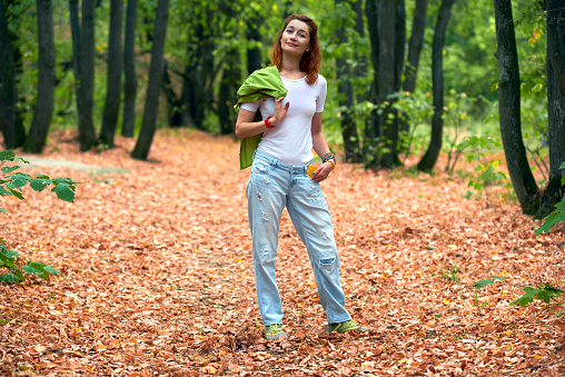Woman walking in the park in autumn