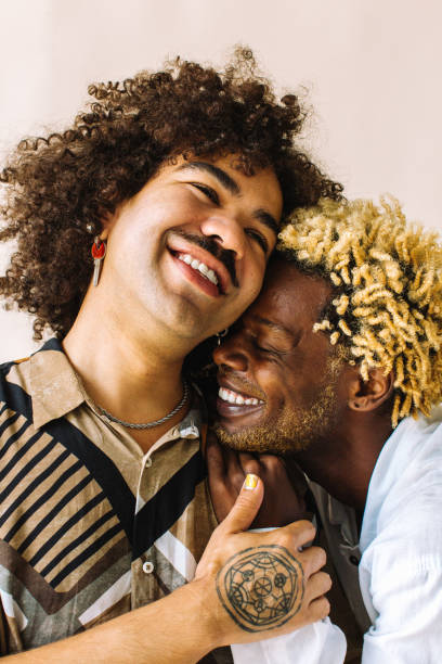 istock Cheerful gay couple embracing each other in a studio 1340975532