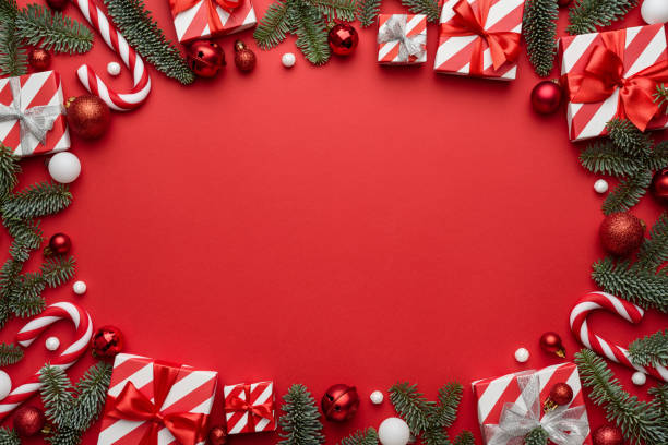 istock Red Christmas background with frame decorated with holiday gifts 1340980189