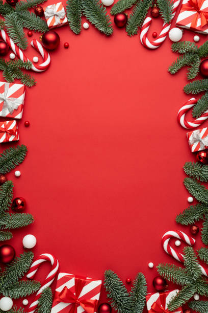 istock Red background with Christmas gift boxes and Christmas decorations frame 1340980219