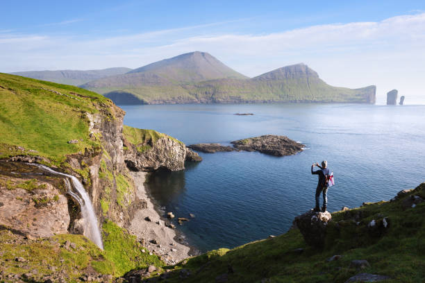 istock Skardsafossur waterfall and Drangarnir sea stacks view on Faroe Islands 1340980829