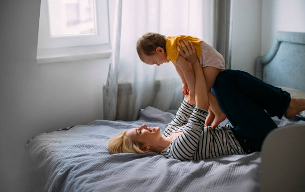 istock Mother and Daughter Having Fun in Bedroom 1340982525
