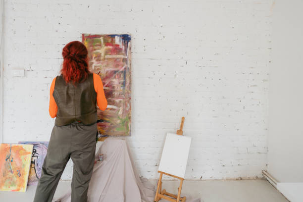 istock Mature woman painting on canvas 1340985667