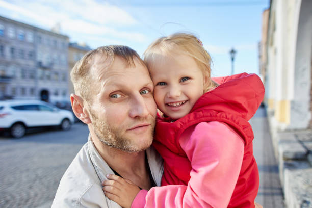 istock Father holds happy child 3 years old while walking outdoors. 1340990322