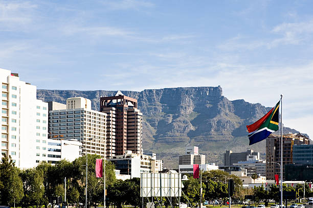 Cape Town with SA flag Table Mountain rises behind downtown Cape Town, South Africa. The South African flag flies at right. Camera: Canon 5D. south africa flag stock pictures, royalty-free photos & images