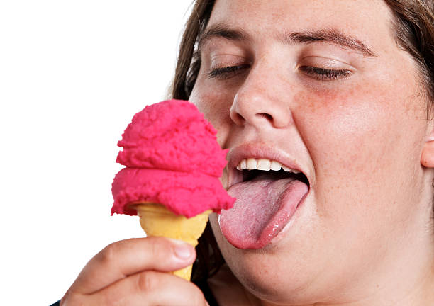 istock Plump woman licks ice cream 134099238