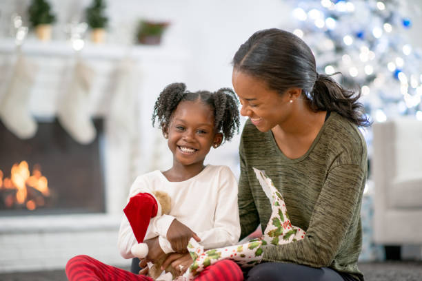 istock Opening up a Gift With Mom on Christmas Day 1340992888