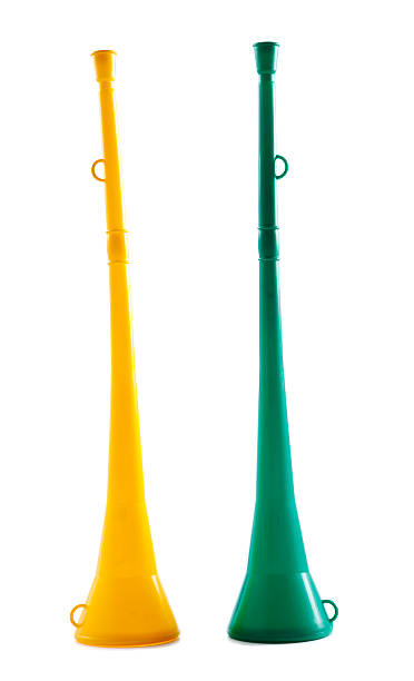 Two vuvuzelas: traditional African soccer fans' one-note plastic trumpets In the South African national sport colors of green and gold. No South African soccer fan would be without at least one vuvuzela during the 2010 World Soccer championships. The noise from these one-note plastic trumpets is deafening, electrifying, and unforgettable. Shot with Canon EOS 1Ds Mark III. vuvuzela stock pictures, royalty-free photos & images