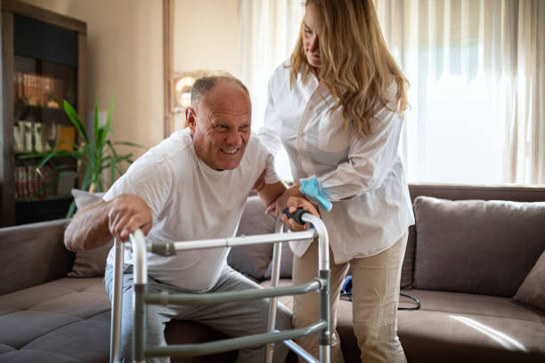 istock Caring wife helping her husband to walk with mobility walker at home 1341001614
