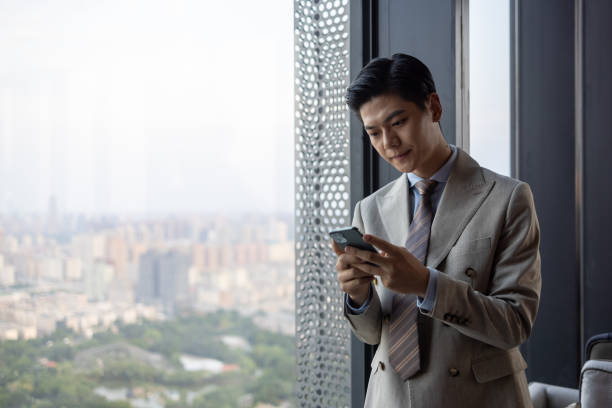 istock Asian businessmen using mobile phones 1341007330