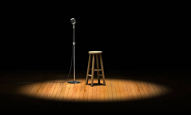 Open Mic Microphone stand and wooden stool under a spotlight on a stage microphone stand photos stock pictures, royalty-free photos & images