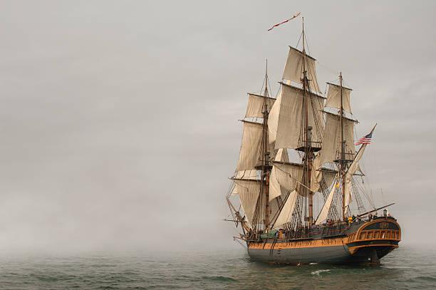 Entering Fog Vintage Frigate sailing into a fog bank warship photos stock pictures, royalty-free photos & images