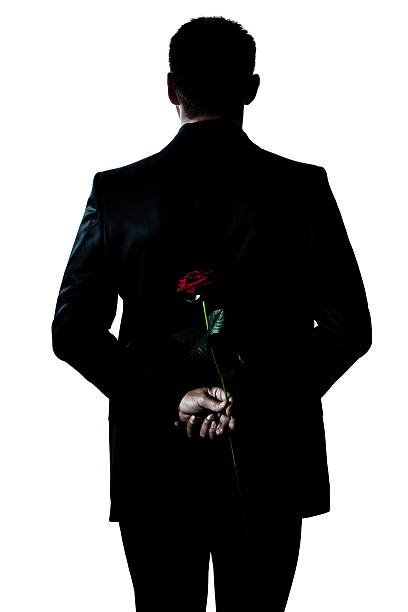 rear view silhouette man portrait holding a rose flower