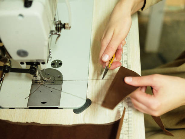istock young woman works in a workshop, sews leather bags 1341017088