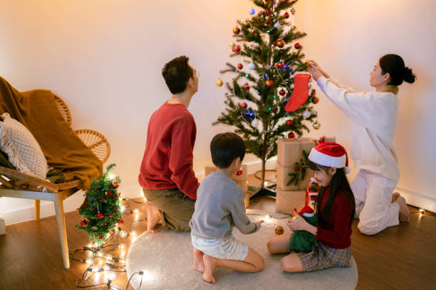 istock Family decorating their christmas tree . 1341020454