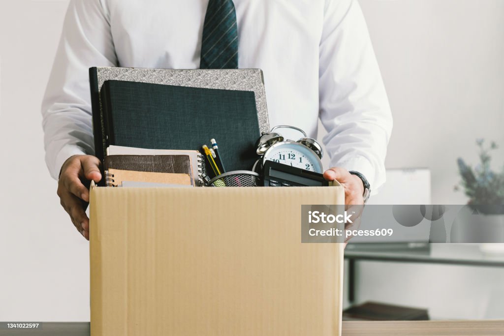 Resignation. businessmen holding boxes for personal belongings and resignation letters.Quitting a job,The big quit.The great Resignation. Quitting a Job Stock Photo