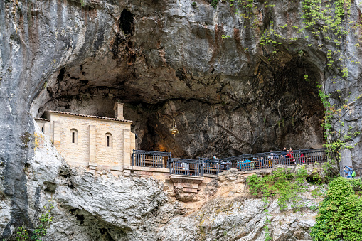 Covadonga, Asturias, Spain - August 4, 2021: The Holy Cave of Our Lady of Covadonga is a catholic sanctuary dedicated to the first battle of the Spanish Reconquest.
