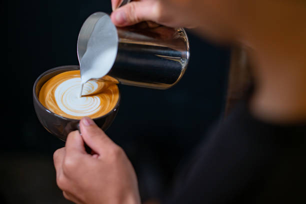istock Close up barista hand making coffee latte in coffee cup 1341023554