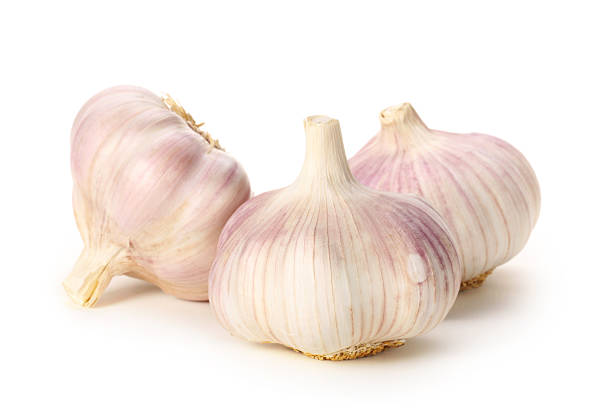 Three garlic Garlic. Three cloves of garlic arranged on a white background close-up acrid taste stock pictures, royalty-free photos & images