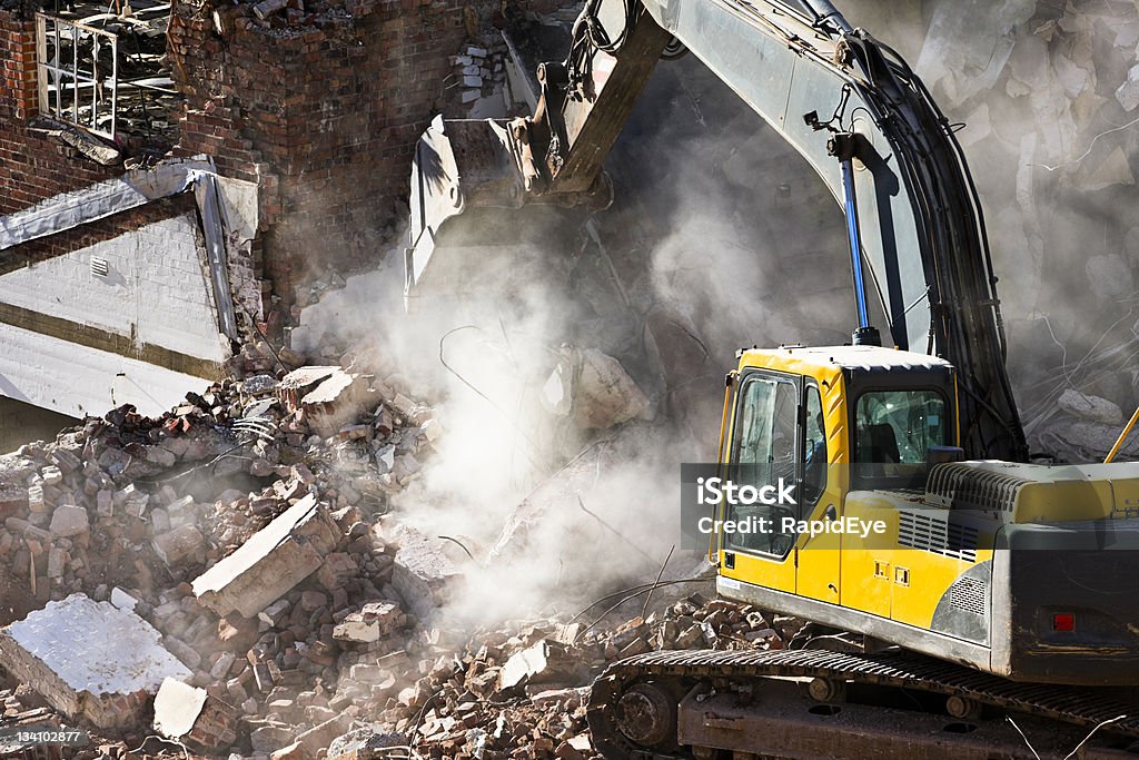 Demolition A digger makes short work of an old building. Camera: Canon EOS 1Ds Mark III. Backhoe Stock Photo