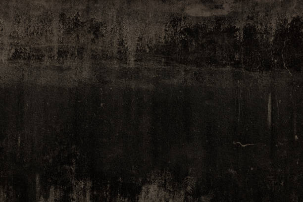 Part of an old and darkened concrete wall.