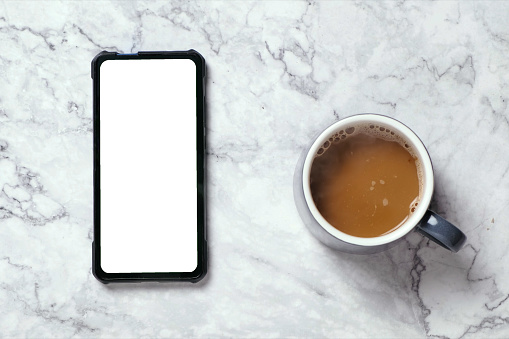 Top view Hot coffee and blank screen smartphone, Smartphone with blank mock-up screen, business concept.