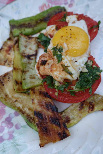 istock Grilled zucchini slices Fried egg Fried tomato with parsley  Meal served 1341032817