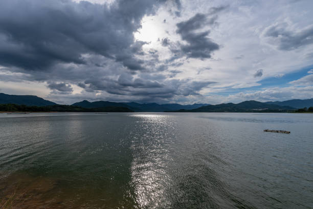 The sky is covered with clouds and there are waves on the water