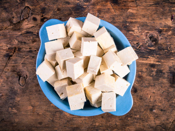 istock Diced tofu cheese in a blue bowl, top view, close-up 1341043471