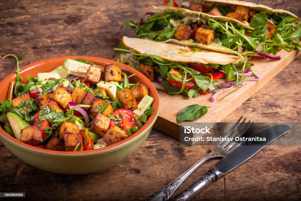Vegan salad bowl with vegetables and fried tofu top view and tacos with vegetable salad - vegetarian cuisine Tofu Stock Photo