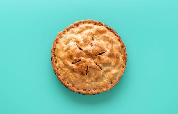 Apple pie above view, isolated on a green background Homemade apple pie above view on a green table. Delicious home-baked apple tart, minimalist on a colored background. sweet pie stock pictures, royalty-free photos & images