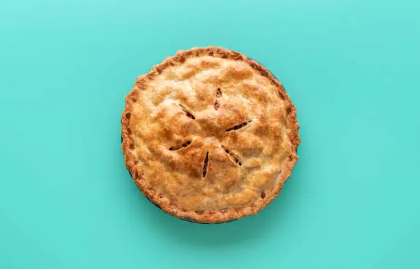 Photo of Apple pie above view, isolated on a green background