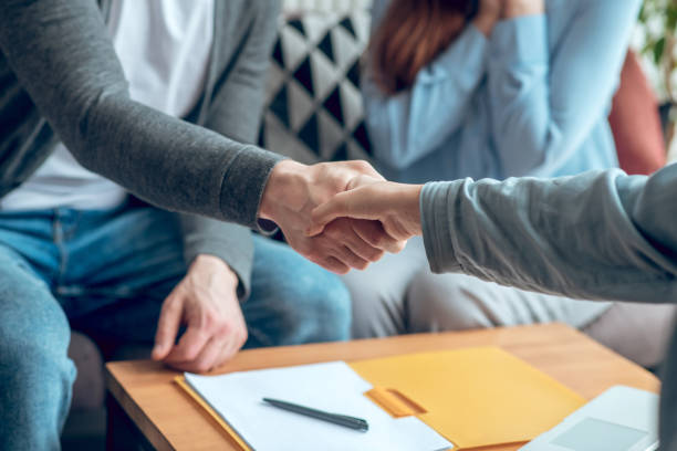 istock Hands in handshake in making deal 1341050375