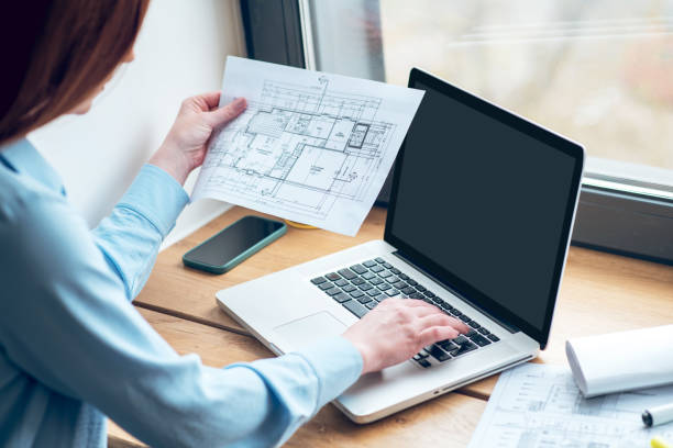 istock Woman with drawing working on laptop 1341050828