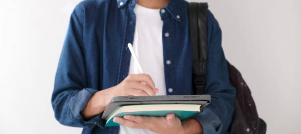 istock Close up of man hand writing on digital tablet while online study, telecommunication 1341053575