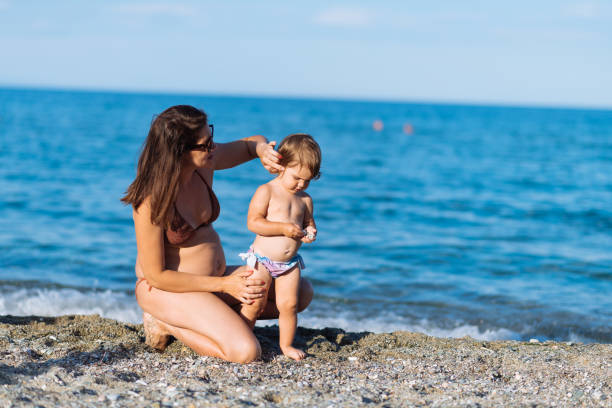 istock Mother and daughters at the beach in summer 1341053720