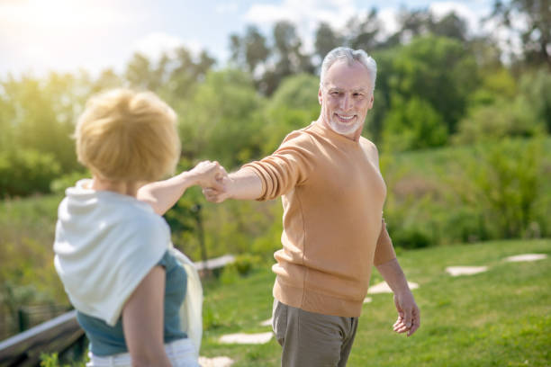 istock Joyous man taking his female dancing partner by the hand 1341056053
