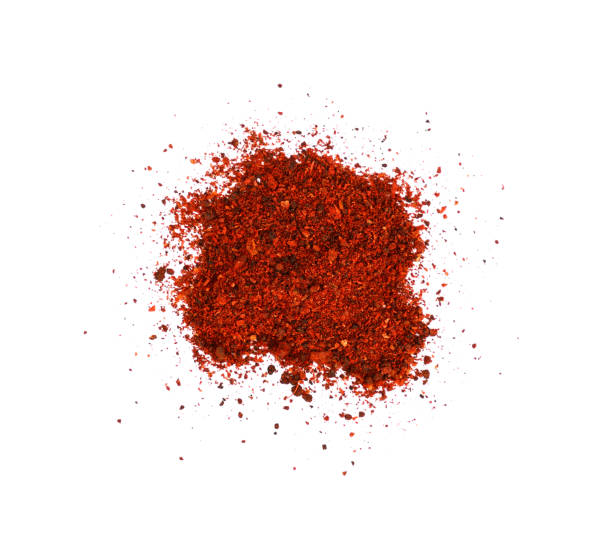 Close up heap of sundried tomatoes Close up heap of ground sundried tomatoes spilled, isolated on white background, elevated top view, directly above chilli powder stock pictures, royalty-free photos & images