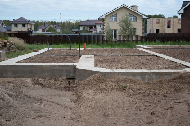 New house concrete foundation. Earth works at construction site