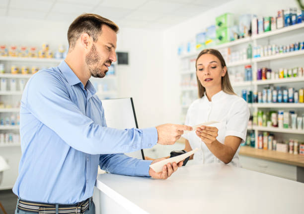 istock Pharmacist talking to a customer in pharmacy store 1341060557