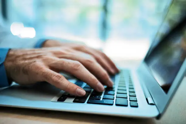 Photo of Business Hands Typing on a laptop