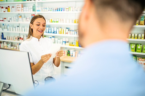 Pharmacist talking to a customer