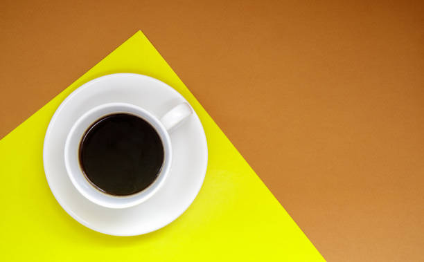 istock Black coffee in a white coffee cup on a gentle background. Top view, flat lay, copy space. Cafe and bar, barista art concept. Freshly made natural or instant coffee in a cup. Coffee background 1341062066