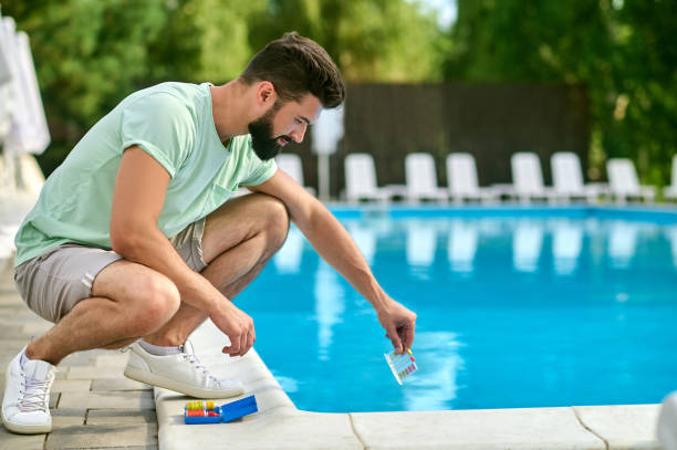istock A service man making a water test in a swimming pool 1341063600